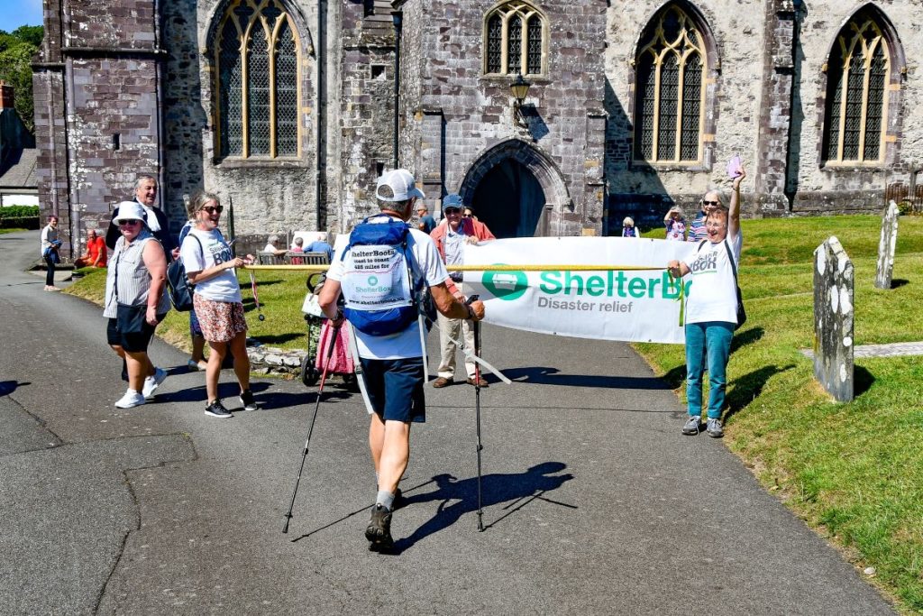 Man walking up to a ShelterBox banner St David's