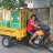 Indonesia man driving a Motorcycle rickshaw with ShelterBoxes in the back