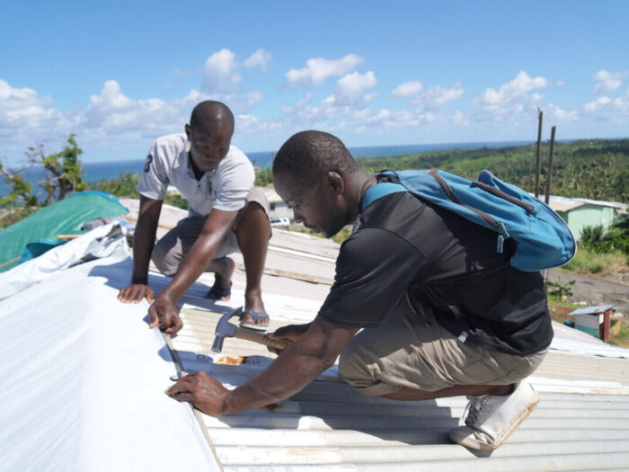 2 men in Dominica fixing a roof