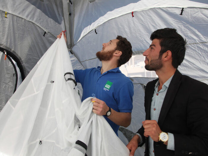 ShelterBox Response Teams putting up a tent.