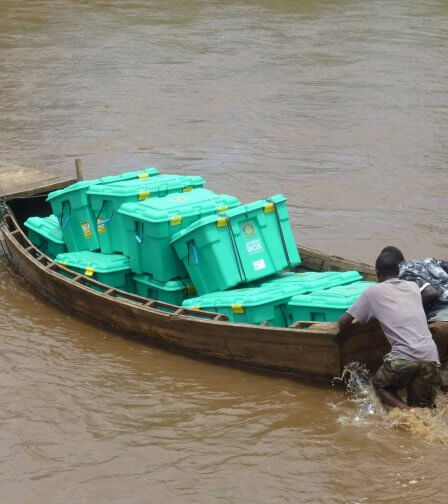 Men pushing wooden boat with ShelterBoxes in Malawi