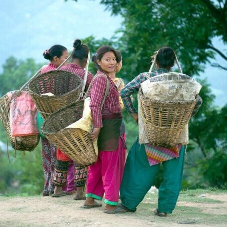 Ladies carrying farming baskets in Nepal