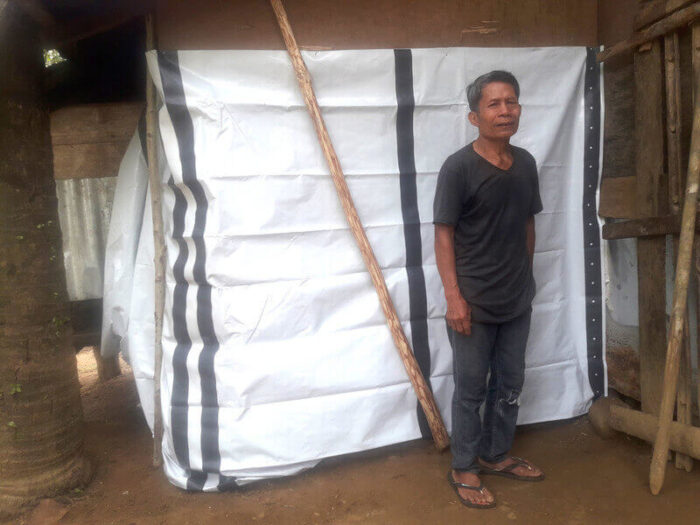 Benito stands in front of his emergency shelter after tropical storm Usman hit the Philippines