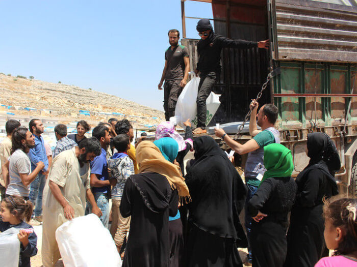 Humanitarian aid workers deliver aid in Syria