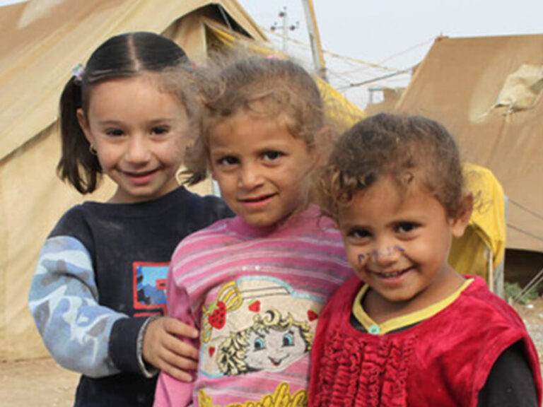 Children standing in front of tents in Iraq