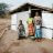 Family standing outside their home in Malawi