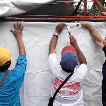 People building shelter after tropical storm on the Philippines