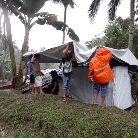 People building shelter after tropical storm on the Philippines