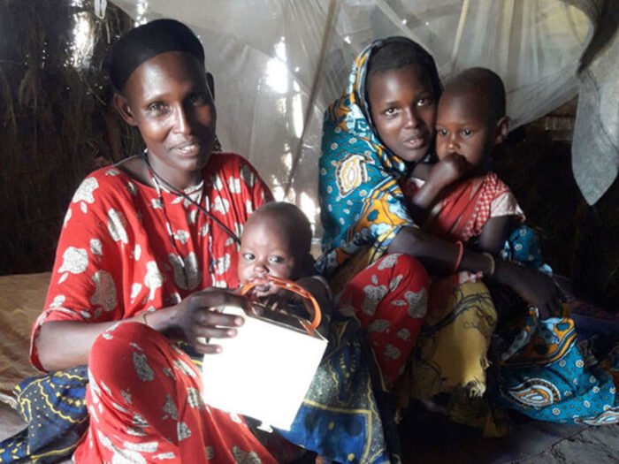 women and children with a solar light in Kenya