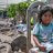 Child sitting on chair between rubble - Flooding in Peru banner