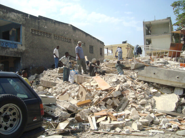 people assessing the damage amongst rubble in Haiti, 2010