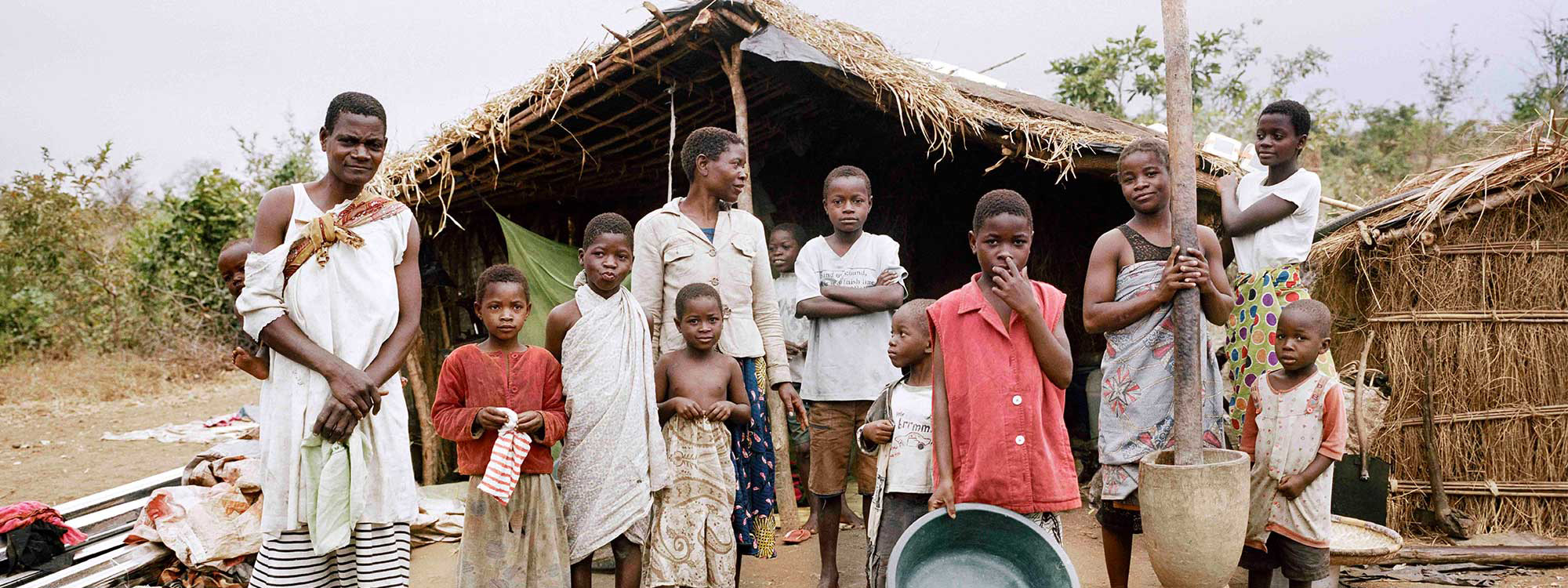 A family standing outside their home in Malawi