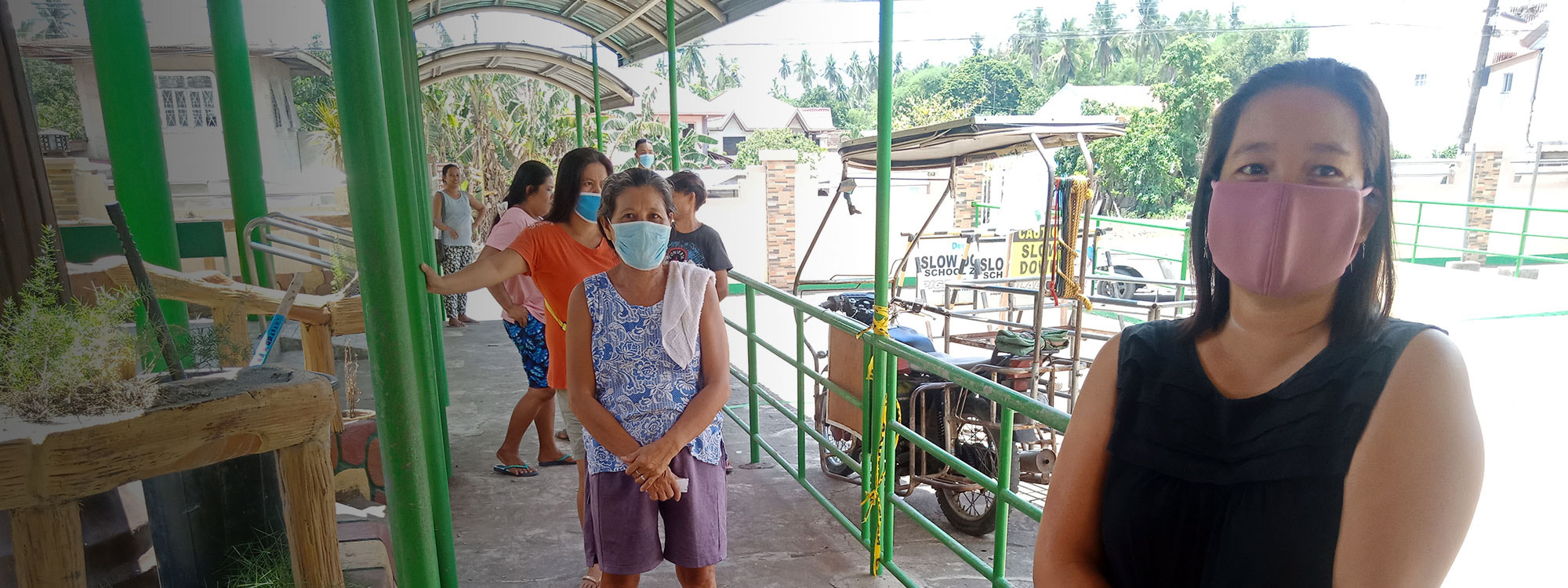People queuing for aid in the Philippines socially distanced and wearing facemasks during the coronavirus pandemic