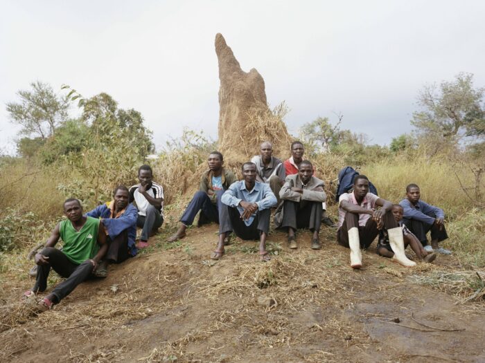 a group of men sat on a small hill