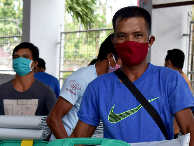 man wearing a mask in the Philippines and receiving ShelterBox aid