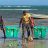 three men carrying shelterboxes on beach