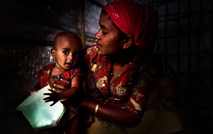 Woman holding baby holding a solar light