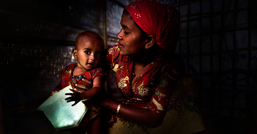 Woman holding baby holding a solar light