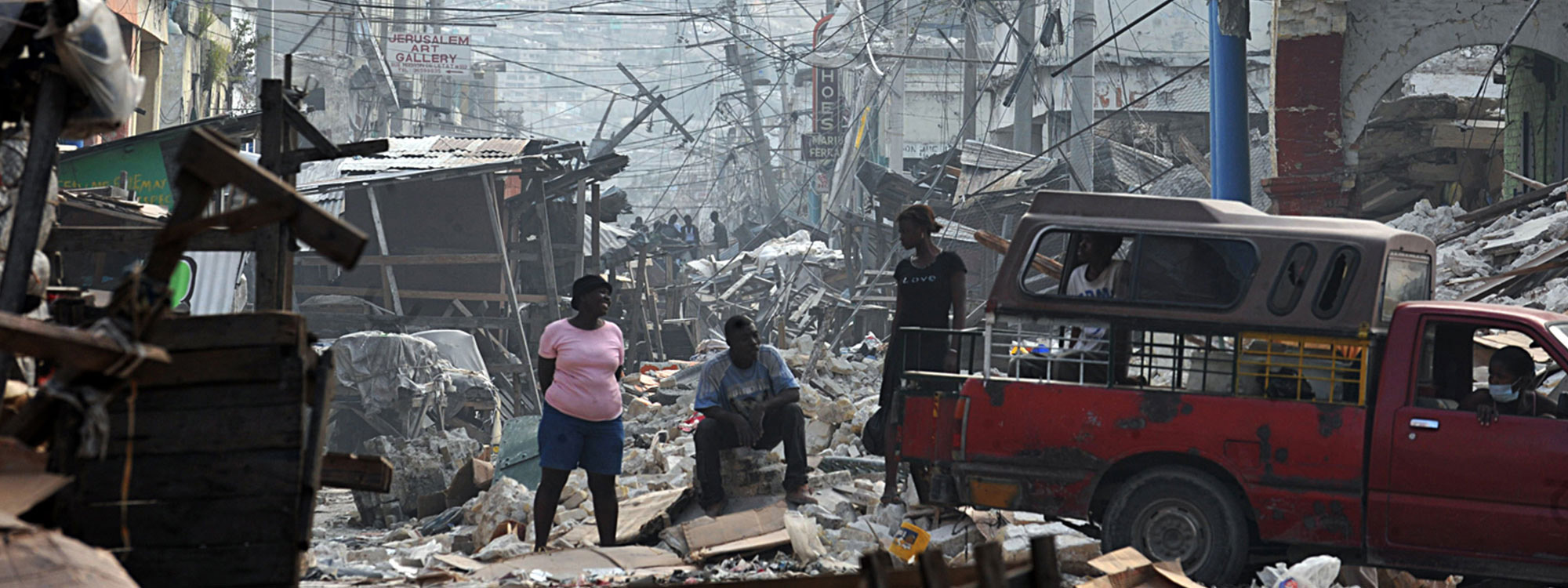 People among earthquake damaged buildings in Haiti
