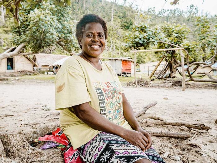 woman smiling sitting on ground in vanuatu