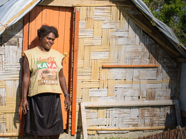 A woman outside her home in Vanuatu