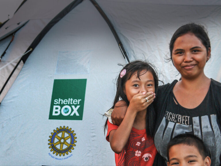 Woman and children outside a ShelterBox tent