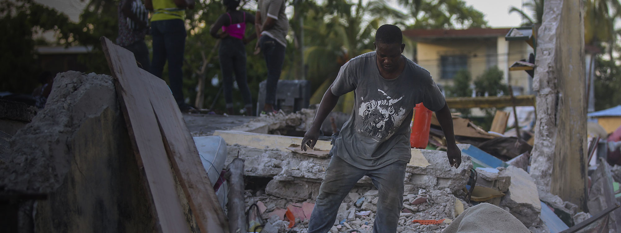 Earthquake, Les Cayes, Haiti 14-Aug-2021. Man tries to recover belongings from his home destroyed by the earthquake. Joseph Odelyn AP Shutterstock