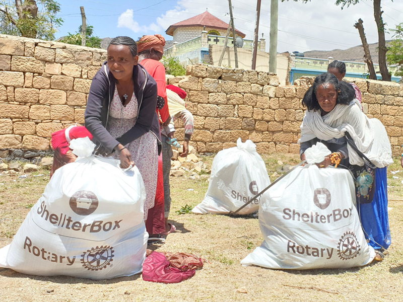 People holding bags with aid in Tigray, Ethiopia