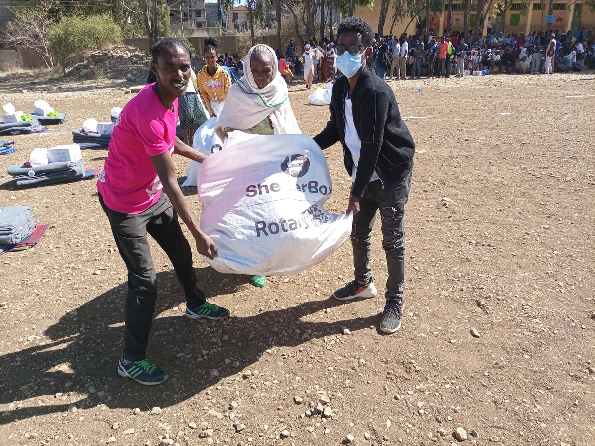 People holding a bag with aid responding to a crisis caused by the Tigray conflict in Ethiopia