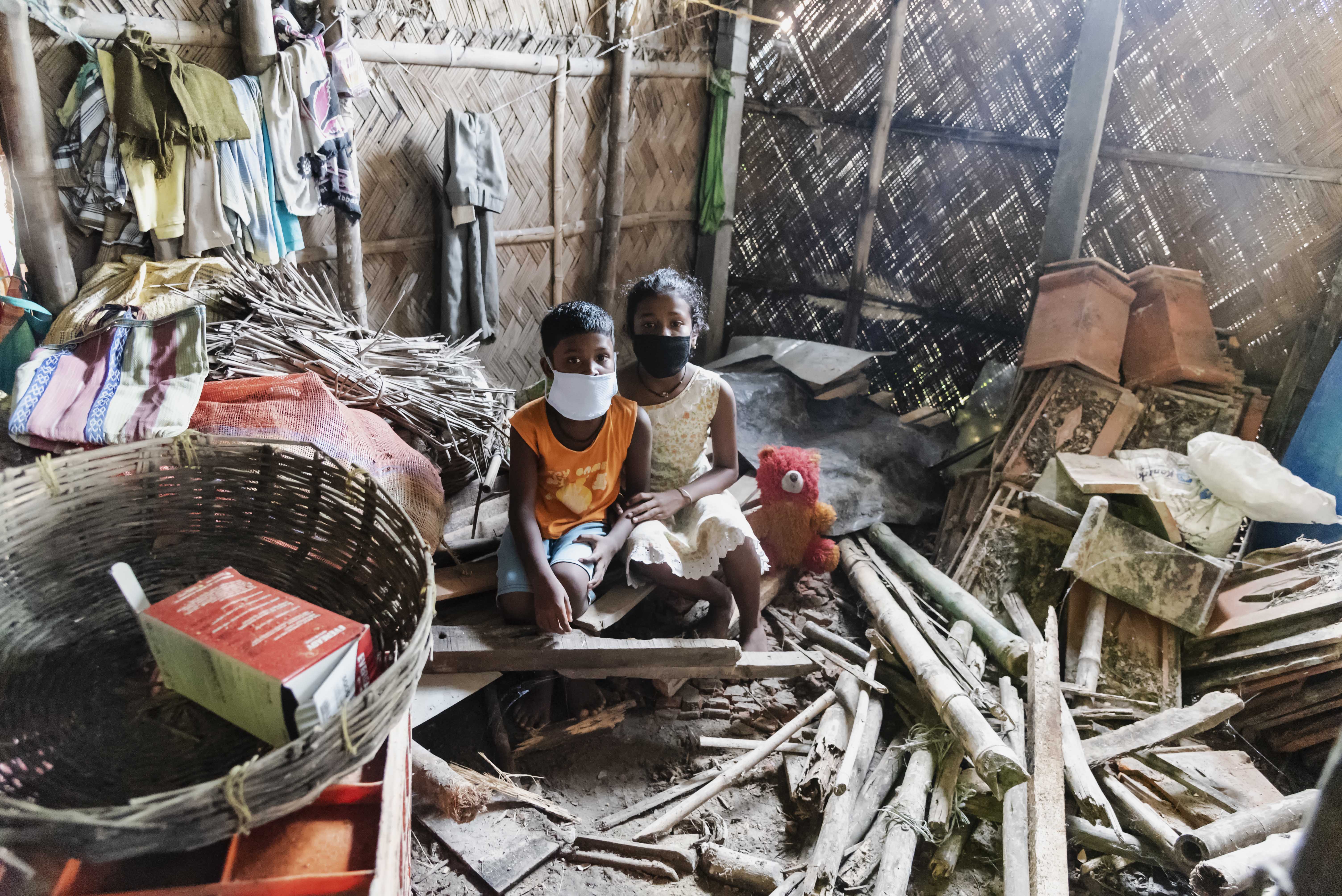 boy and girl hugging in destroyed home
