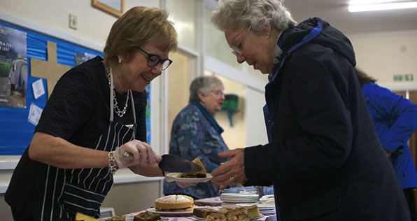 two women at charity bake sale