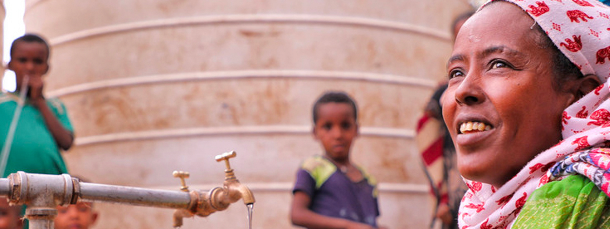 Woman, children and a water tap in Tigray, Ethiopia.