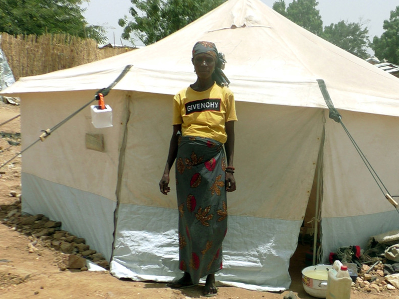 Woman standing in front of a tent