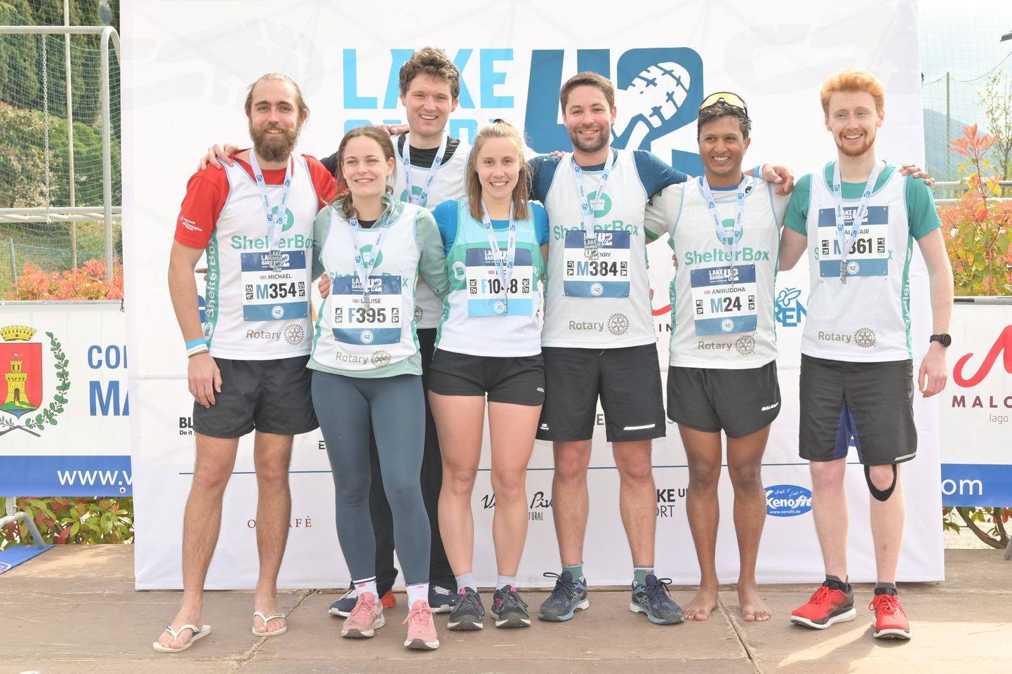 A group of people posing together before running a marathon
