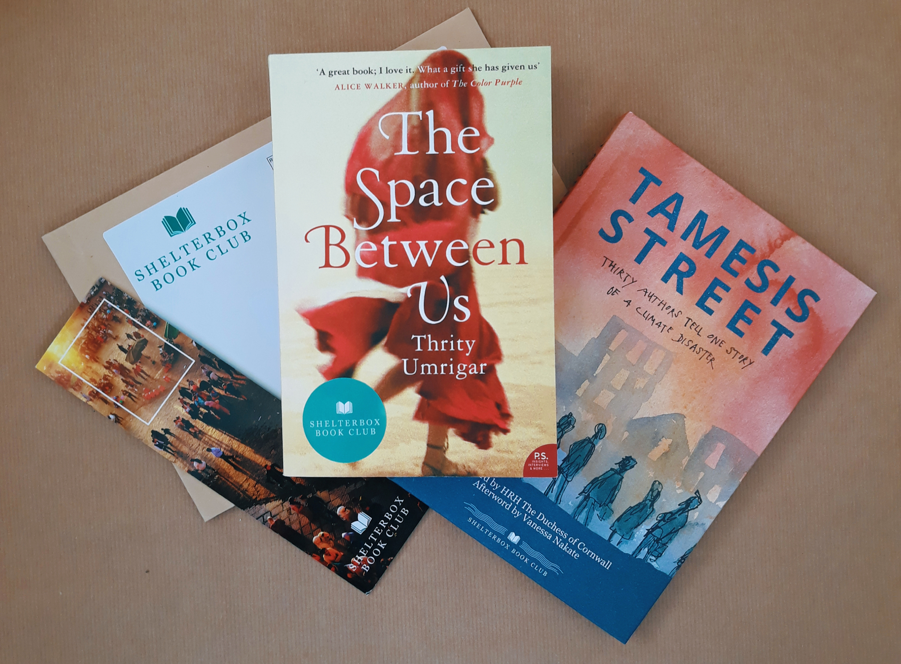 A selection of books from ShelterBox Book Club, with a book mark and envelope