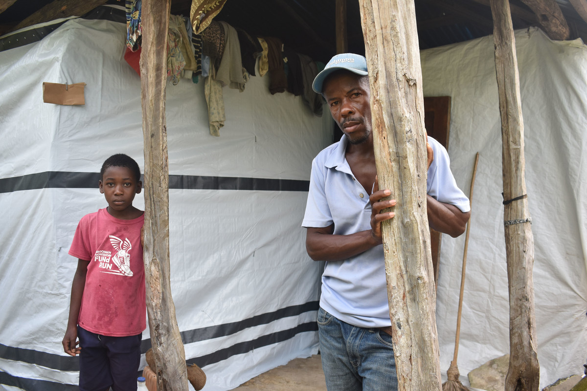 A man and a boy outside a makeshift shelter in Haiti after the 2021 earthquake