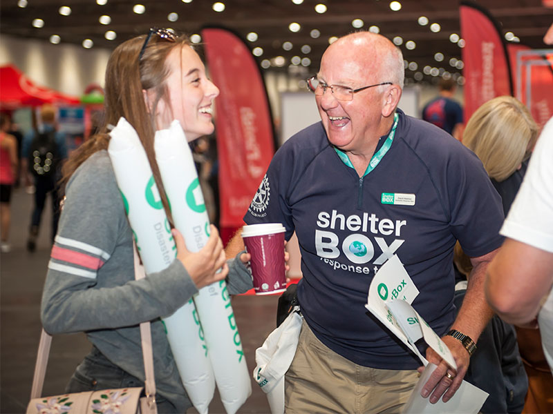 two shelterbox volunteers laughing