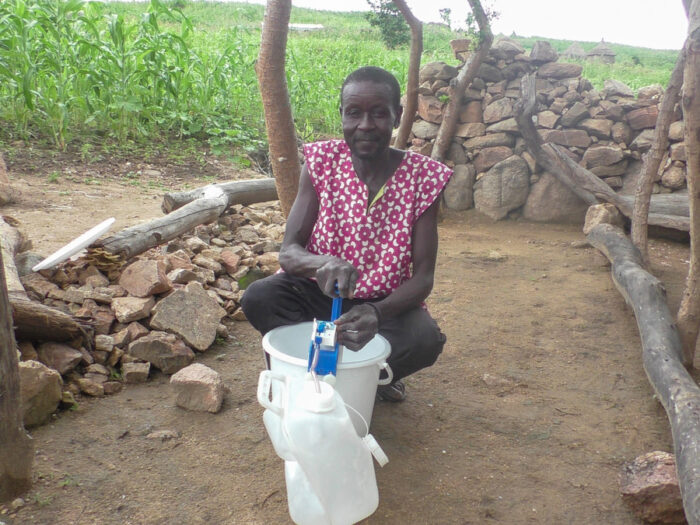 Man using water filter in Cameroon