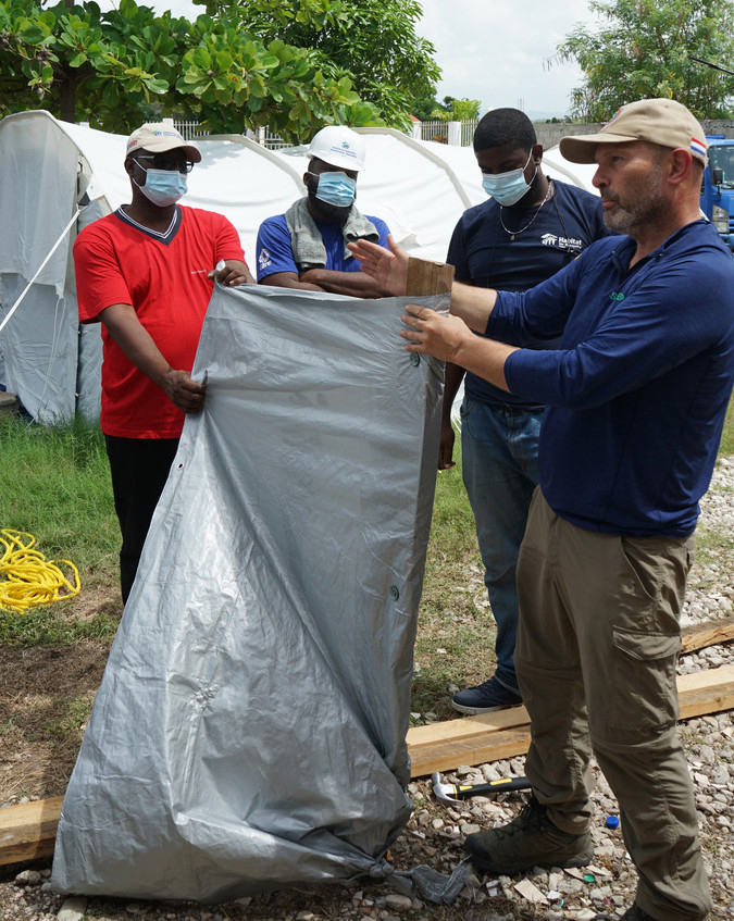 people carrying out training in the use of shelter materials after the Haiti earthquake