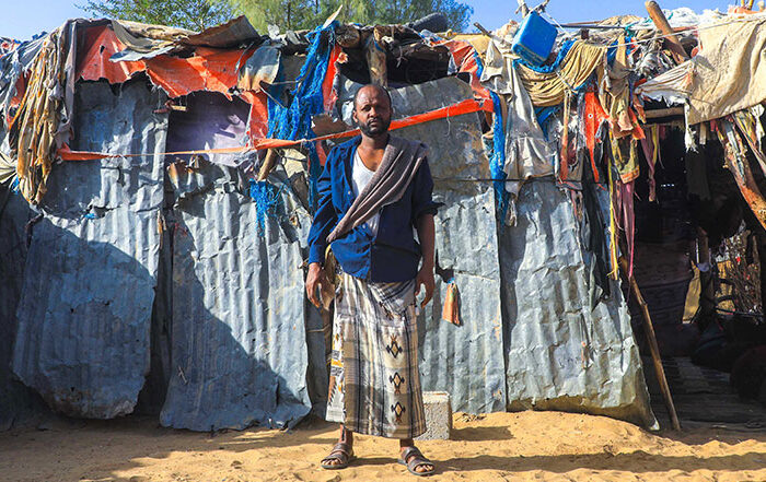 man standing in front of shelter in yemen