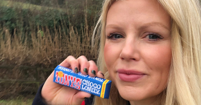 Woman with blonde hair holding a chocolate bar