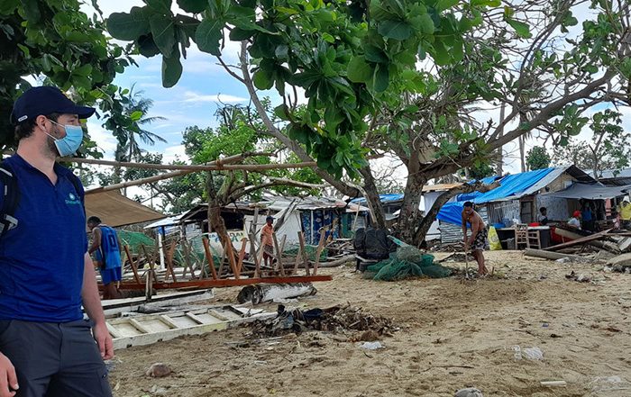 Man wearing facemask looking at makeshift camp in Philippines