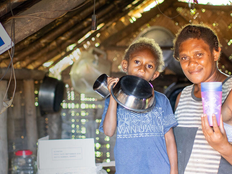 woman and child with kitchen items in vanutau