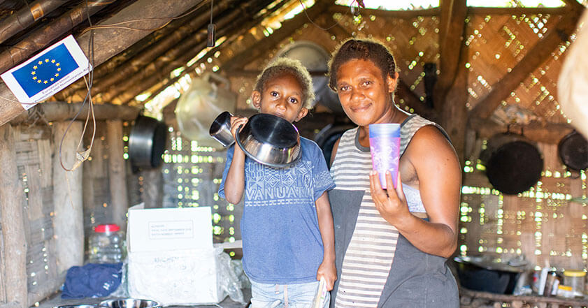 Woman and child with kitchen utensils in Vanuatu