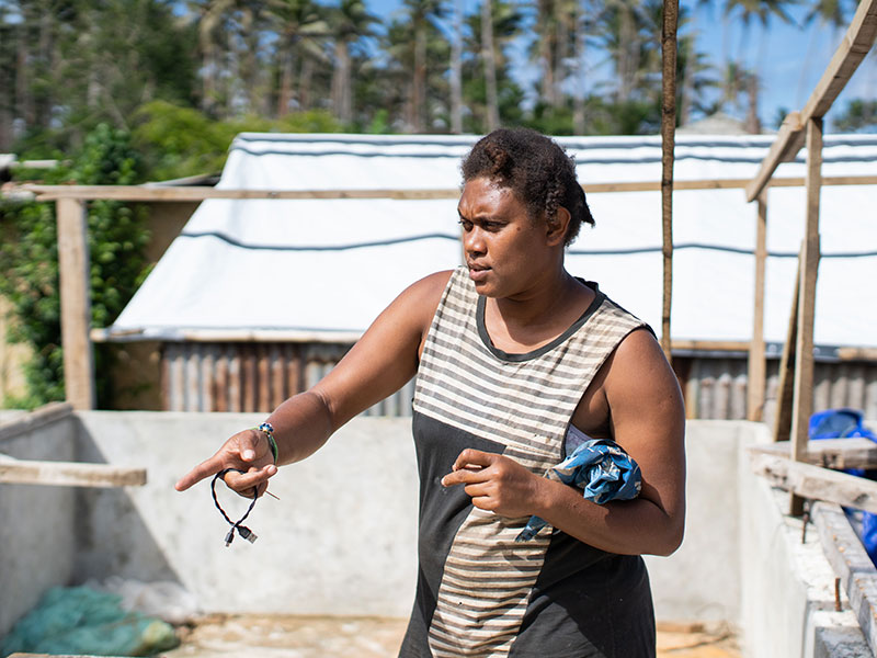 woman rebuilding her home in vanuatu after cyclone harold