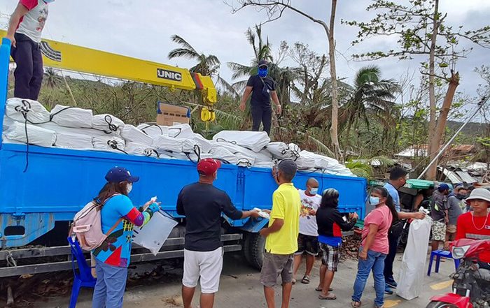 People in the Philippines receiving aid distributed from a truck in the Philippines