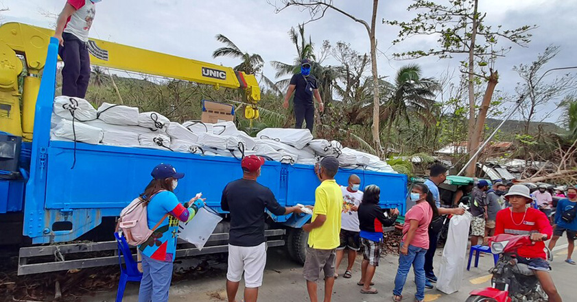 People in the Philippines receiving aid distributed from a truck in the Philippines