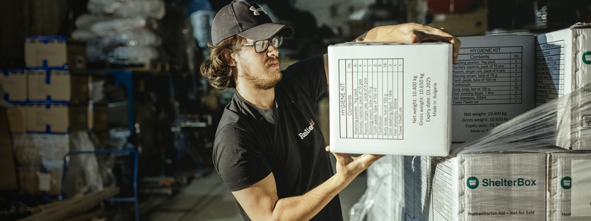 Man unloading boxes at a warehouse.