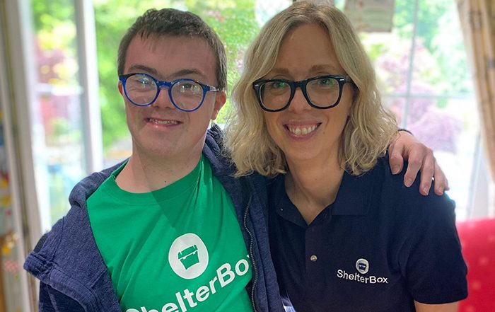 Man and woman wearing ShelterBox tshirts