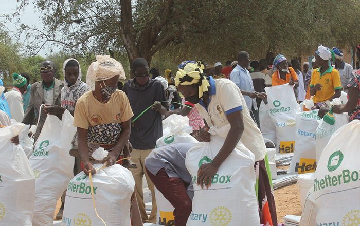 People collecting bags of aid in Burkina Faso